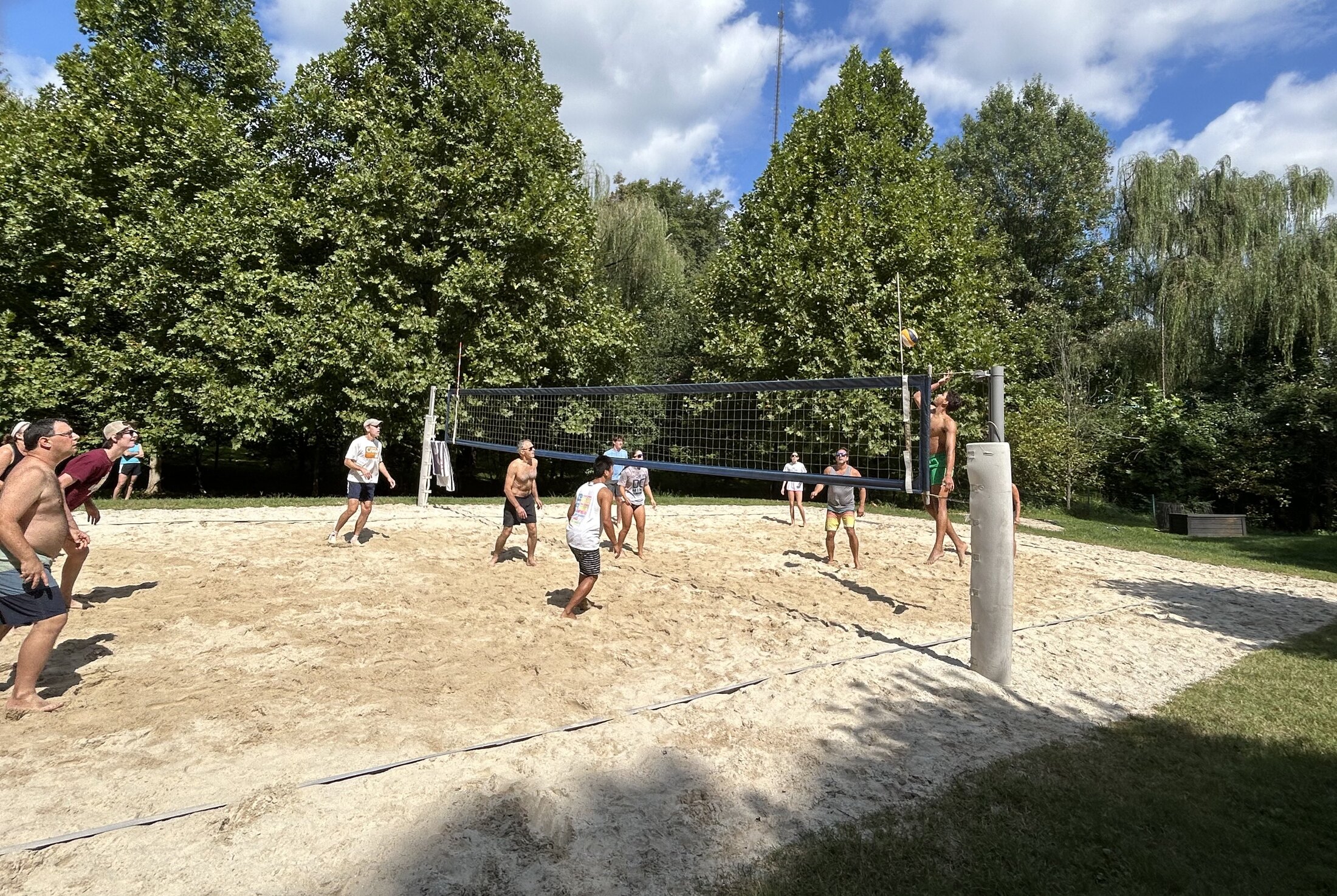 Players rallying on the Rock Creek Forest sand volleyball court