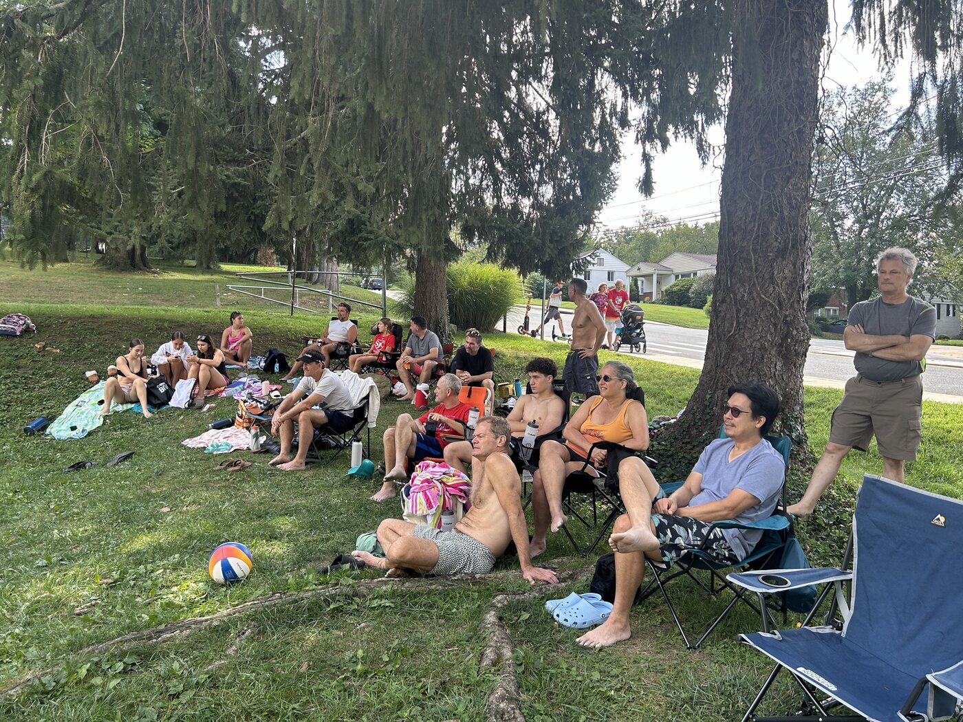 Spectators relaxing in the shade beside the court